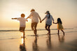 © Garun Studios - Happy asian family at consisting father, mother,son and daughter having fun playing beach in summer vacation on the beach.Happy family and vacations concept.
