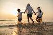 © Garun Studios - Happy asian family at consisting father, mother,son and daughter having fun playing beach in summer vacation on the beach.Happy family and vacations concept.
