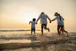 © Garun Studios - Happy asian family at consisting father, mother,son and daughter having fun playing beach in summer vacation on the beach.Happy family and vacations concept.