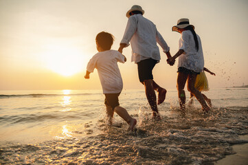 happy family beach sunset. children vacations. daughter mother father. having fun playing beach in s