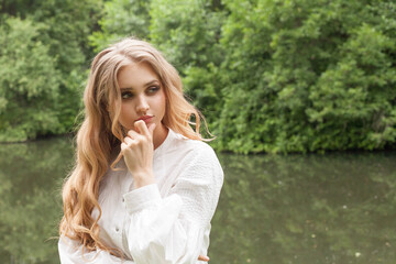 Wall Mural - thinking woman blonde outdoor, closeup portrait