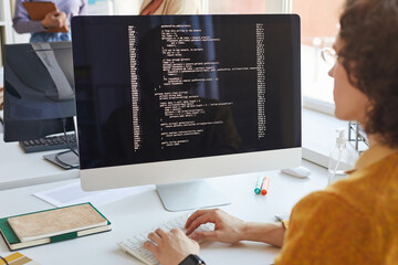 software engineer writing code at computer
