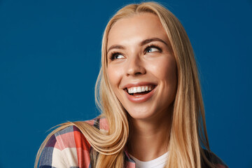 Blonde young happy woman smiling and looking aside