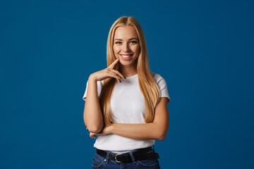 Blonde young happy woman smiling and looking at camera