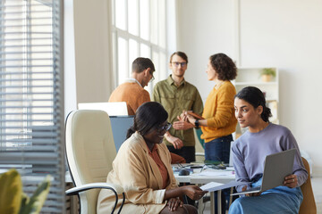 Two Ethnic Businesswomen Talking in Office