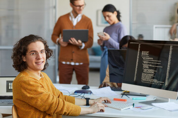 Young Man Programming Software in Office