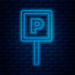 Glowing neon line Parking icon isolated on brick wall background. Street road sign. Vector