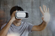 © anut21ng Stock - Young man wearing virtual reality goggles headset, vr box. Connection, technology, new generation, progress concept
