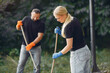© prostooleh - Couple collects leaves and cleans the park