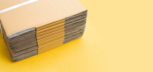 Wall Mural - Stacking of cardboard boxes, Corrugated paper on yellow