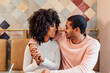 © MyMicrostock/Stocksy - Happy couple in love sitting in cafe