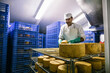 © Inuk Studio/Stocksy - Man in cheese factory storage