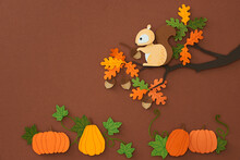 Squirrel Sits On A Tree Branch And Gnaws A Nut In Woods. Paper Cut Style