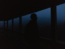 Man In Hat Standing On The Terrace In The Night