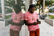 © Mauro Grigollo Photographer/Stocksy - Black man using mobile phone in Miami