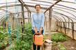 © Mihajlo Ckovric/Stocksy - Woman working in a greenhouse