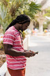 © Mauro Grigollo Photographer/Stocksy - Black man using mobile phone in Miami