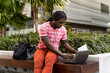 © Mauro Grigollo Photographer/Stocksy - African american man working outdoor with his laptop