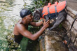 © Kristen Curette Photography LLC/Stocksy - Young man swimming with his dog