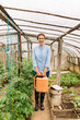 © Mihajlo Ckovric/Stocksy - Woman working in a greenhouse