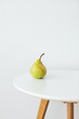 © Sophia Hsin/Stocksy - Still life of pear on white table