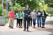 © Sean Locke Photography/Stocksy - Tour: Guide Leads Group Through College Campus