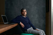 © Floris Productions/Stocksy - Portrait of a young Indian Phd professor