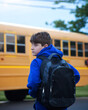 © Angela Waye/Stocksy - Middle School Boy Student Waiting at Bus Stop