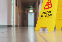 Yellow Sign Of Slippery Floor In The Room After Cleaning
