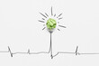 © Yaroslav Danylchenko/Stocksy - Drawn cardiac line with bulb from crumpled paper.