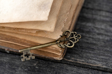 Retro Key And Opened Book On Wooden Table