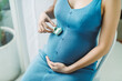 © Maki Company Limited/Stocksy - Small car toy on the belly of pregnant woman