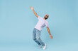 Full length young cool smiling happy funny unshaven black african man 20s wearing violet t-shirt hat glasses standing on toes leaning back dancing isolated on pastel blue background studio portrait.