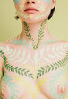 © Liliya Rodnikova/Stocksy - Unrecognizable model breast with leaves pattern on skin
