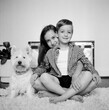 © Jakob Lagerstedt/Stocksy - Sister and brother sitting together with their dog