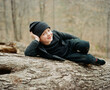 © Jakob Lagerstedt/Stocksy - Cute young boy posting on a fallen tree