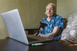 © Oleksii Syrotkin/Stocksy - Granny having online consultation with doctor