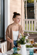© Alina Hvostikova/Stocksy - Happy woman during healthy lunch on terrace
