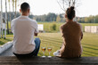 © Alina Hvostikova/Stocksy - Unrecognizable couple with wine resting on porch