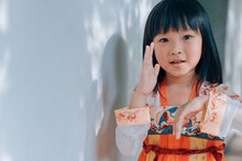Chinese Little Girl Wearing Traditional Cloth In Garden