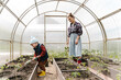 © Alina Hvostikova/Stocksy - Mother and son working in greenhouse