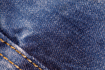 Jeans background. Denim fabric with seams close-up.