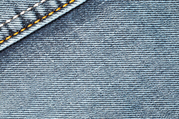 Jeans background. Denim fabric with seams close-up.