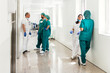 © Nunez Image/Stocksy - Group of Medical Workers Chatting in Hallway