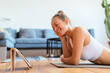 © BONNINSTUDIO/Stocksy - Happy sportswoman watching video on tablet