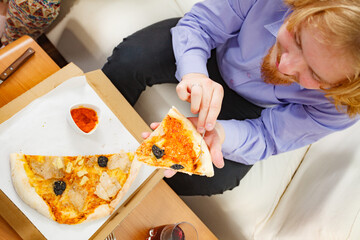 Sticker - Man eating pizza adding tomato sauce