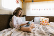 © Mihajlo Ckovric/Stocksy - Girl working on her laptop in a trailer