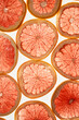 © Juno/Stocksy - Pomelo or grapefruit slice background