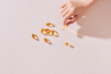 Woman Hand Holding Fish Oil Capsules