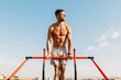 © MyMicrostock/Stocksy - Muscular sportsman doing pull ups